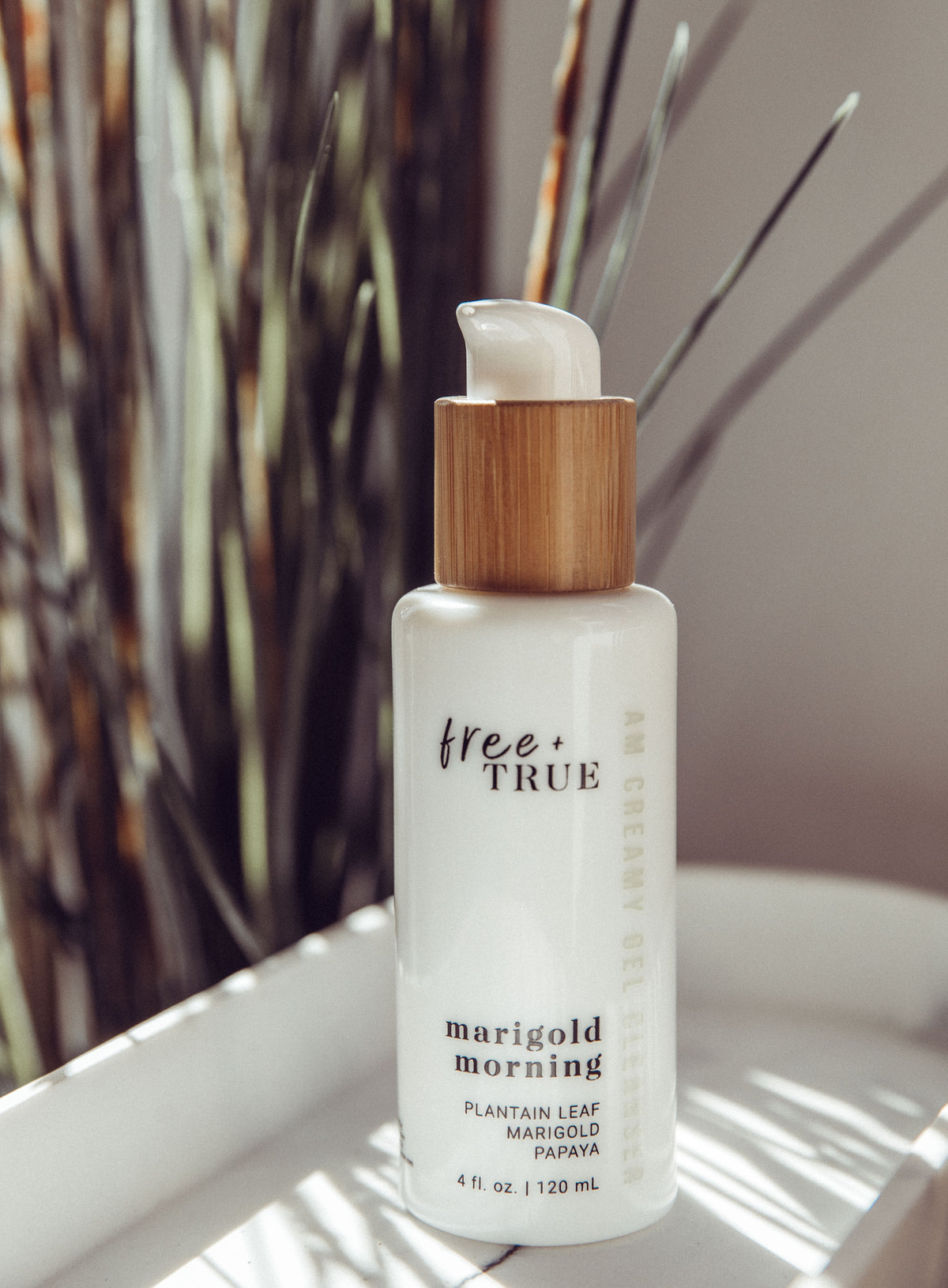 Marigold Morning cleanser — upright bottle with botanicals