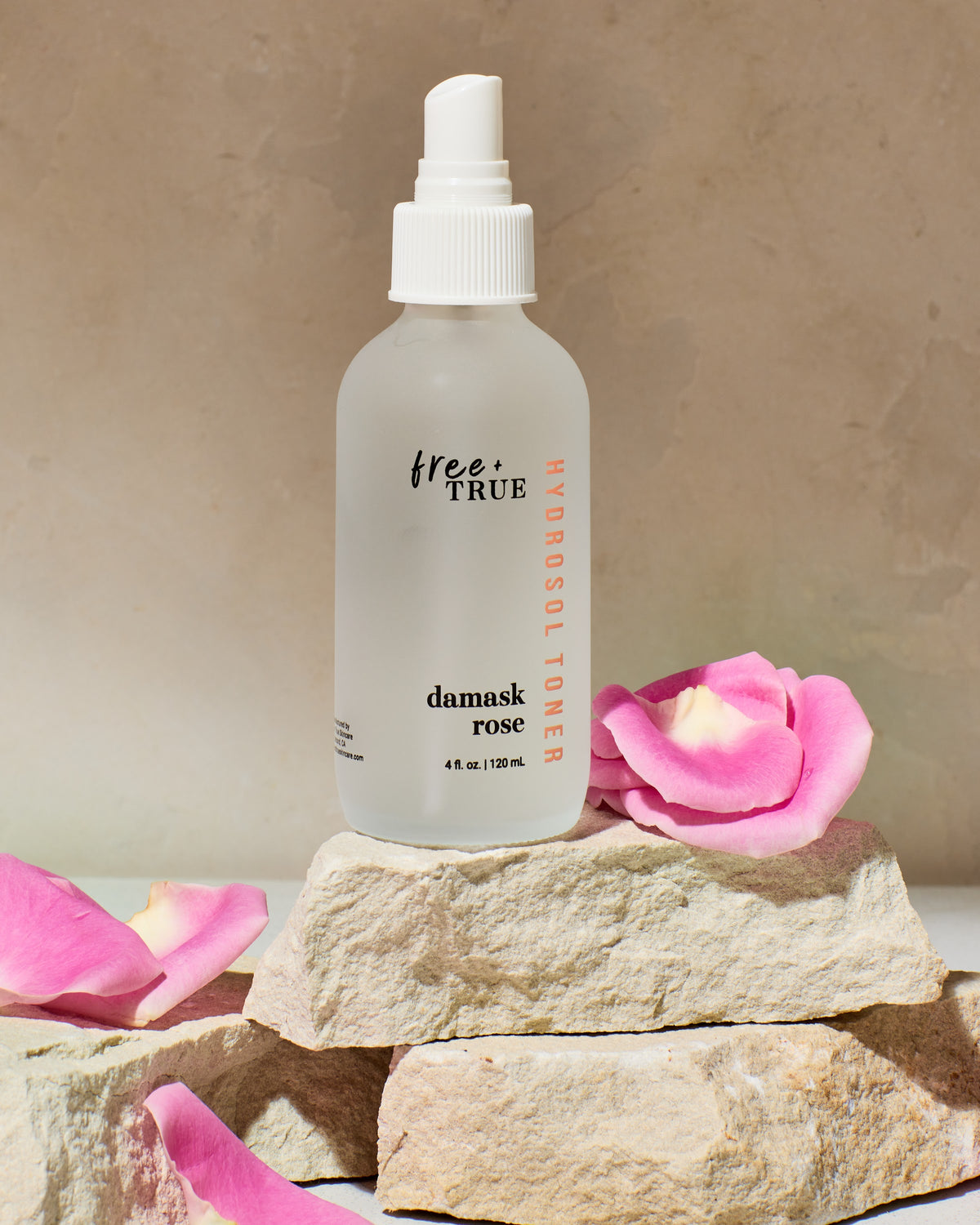Damask Rose hydrosol toner on stone with botanicals