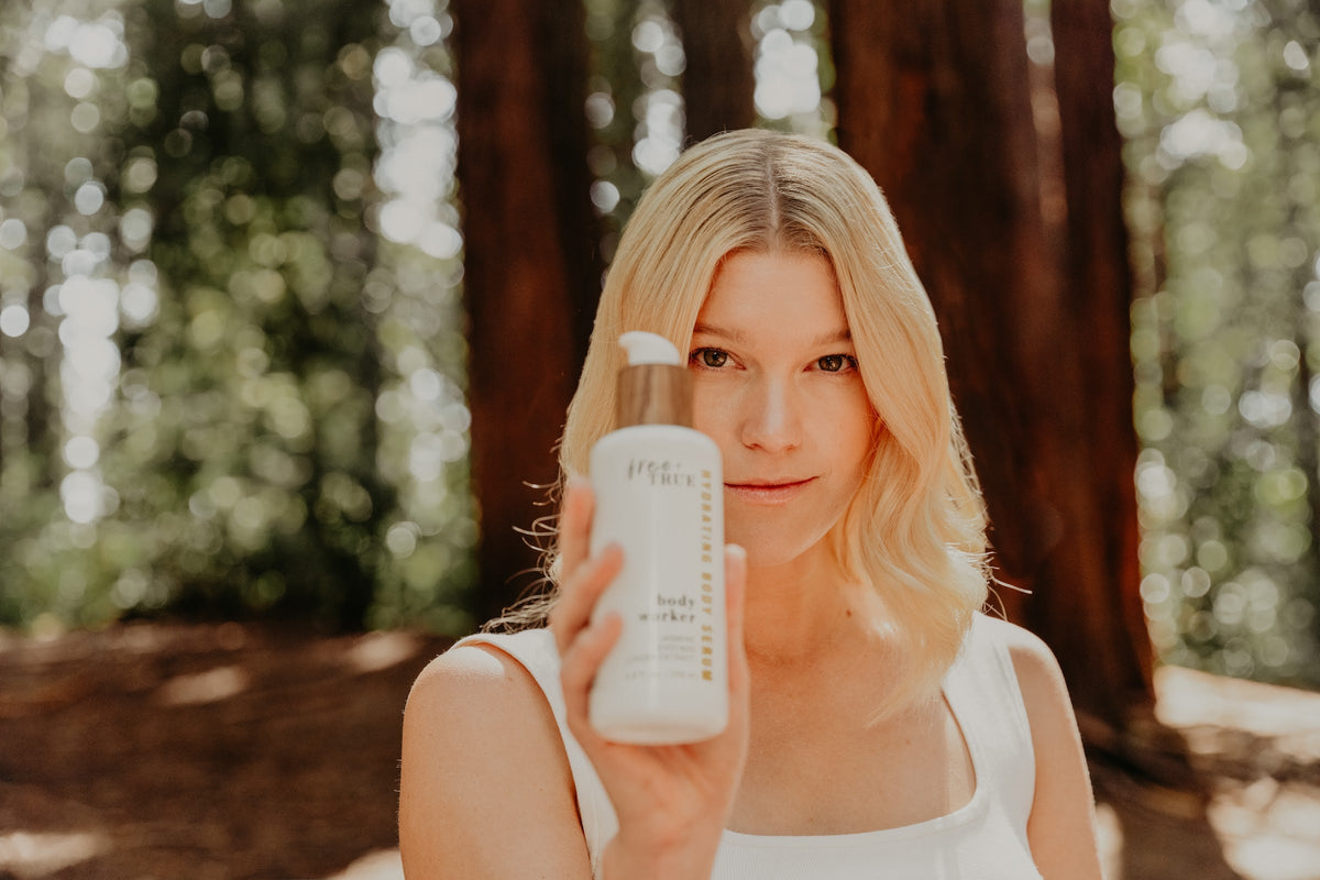 Body Worker — forest portrait holding the bottle
